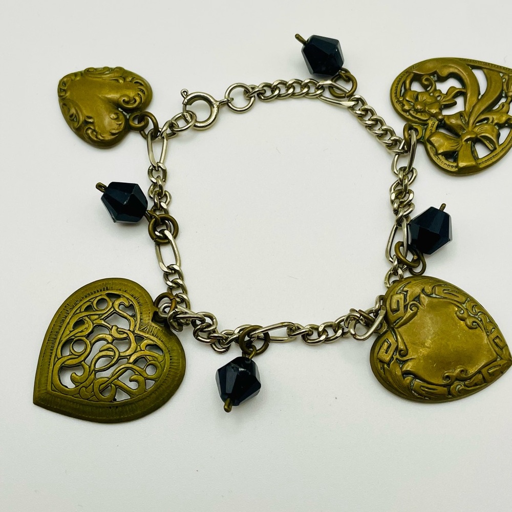 Silver Tone Bracelet with Gold Tone filigree Hearts and Black Beads. 7 inches